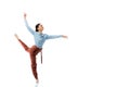 Cheerful professional ballerina dancing on white