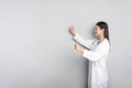 Cheerful professional female doctor standing against background