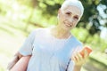 Cheerful progressive pensioner wearing earphones while walking