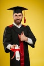 Cheerful, proud student holding diploma, showing super.