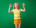 Cheerful pupil against green background