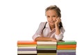 cheerful pupil smiling while looking at camera near colorful books isolated on white.