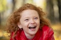 Cheerful red-haired girl laughing merrily Royalty Free Stock Photo