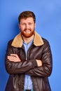 Cheerful redhead caucasian guy in warm coat posing at camera Royalty Free Stock Photo