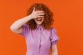 Cheerful redhead girl covering mouth with hands isolated Royalty Free Stock Photo