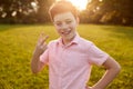 Content boy showing two fingers gesture Royalty Free Stock Photo