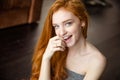 Cheerful redhead woman looking at camera