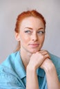 Cheerful redhead woman smiling, thinking of something nice