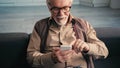 cheerful retired man in eyeglasses texting Royalty Free Stock Photo