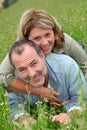 Cheerful retired people relaxing in grass