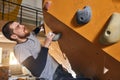 Cheerful rock-climber without forearm training at indoor bouldering gym Royalty Free Stock Photo