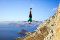 Cheerful rock climber swinging on rope upside down Royalty Free Stock Photo