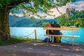 Cheerful romantic couple on the bench in the rain, Bled