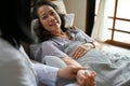 A cheerful 60s aged Asian woman resting in the recovery room Royalty Free Stock Photo