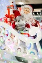 Cheerful Santa carries gifts to children on his sleigh with reindeer macro photo Royalty Free Stock Photo