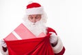 Cheerful Santa Claus is carrying a bag of presents Royalty Free Stock Photo