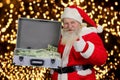 Cheerful Santa Claus with case of money. Royalty Free Stock Photo
