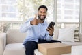 Cheerful satisfied young African client man making like hand gesture Royalty Free Stock Photo