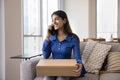 Cheerful satisfied young Indian consumer woman holding paper cardboard box Royalty Free Stock Photo