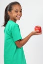 Cheerful school girl 10 smiling holding red apple Royalty Free Stock Photo