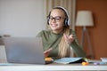 Cheerful school girl joining online lesson, home interior Royalty Free Stock Photo