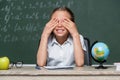 cheerful schoolgirl covering eyes with hands Royalty Free Stock Photo