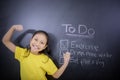 Cheerful schoolgirl standing with lists of to do