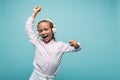 Cheerful schoolkid listening music in headphones