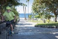 Cheerful senior active man riding at sea with his electric bicycle and yellow helmet - horizon over sea, healthy lifestyles for Royalty Free Stock Photo