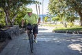 Cheerful senior active man riding at sea with his electric bicycle and yellow helmet - horizon over sea, healthy lifestyles for Royalty Free Stock Photo