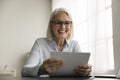 Cheerful senior business professional woman in glasses holding document Royalty Free Stock Photo