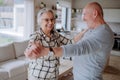 Cheerful senior couple dancing together at home. Royalty Free Stock Photo