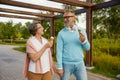 Cheerful senior couple eating ice-cream cone in park enjoying relax time Royalty Free Stock Photo