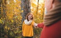 A senior couple on a walk in an autumn nature at sunset, holding hands. Royalty Free Stock Photo