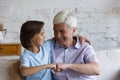 Cheerful senior granddad and grandson giving friendly fist bump