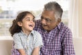 Cheerful senior Indian grandfather holding sweet little granddaughter kid Royalty Free Stock Photo