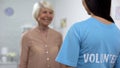 Cheerful senior lady smiling to female volunteer, support in nursing home Royalty Free Stock Photo