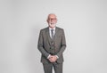 Cheerful senior male manager in eyeglasses smiling and posing confidently on white background Royalty Free Stock Photo