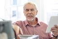 Cheerful senior man checking configurations of 3D printer Royalty Free Stock Photo