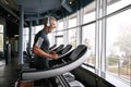 Cheerful senior man exercising on treadmill in gym Royalty Free Stock Photo