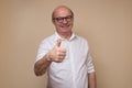 Cheerful senior man giving thumb up approving your choice Royalty Free Stock Photo