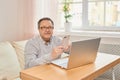 Cheerful senior man has phone conversation from home. Royalty Free Stock Photo