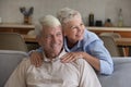 Cheerful senior married couple relaxing in home living room Royalty Free Stock Photo