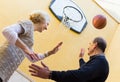 Mature couple playing basketball in patio Royalty Free Stock Photo