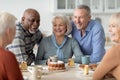 Cheerful senior people drinking tea with cake together Royalty Free Stock Photo