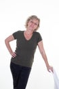 Cheerful senior sixties woman standing hair blonde near seat on white background