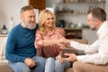 Cheerful Senior Spouses Shaking Hands With Real Estate Agent Indoors Royalty Free Stock Photo