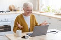 Cheerful senior woman having online class, talking to teacher Royalty Free Stock Photo