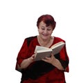 Cheerful senior woman reads book Royalty Free Stock Photo