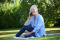 Cheerful senior woman sitting down talking on the phone Royalty Free Stock Photo